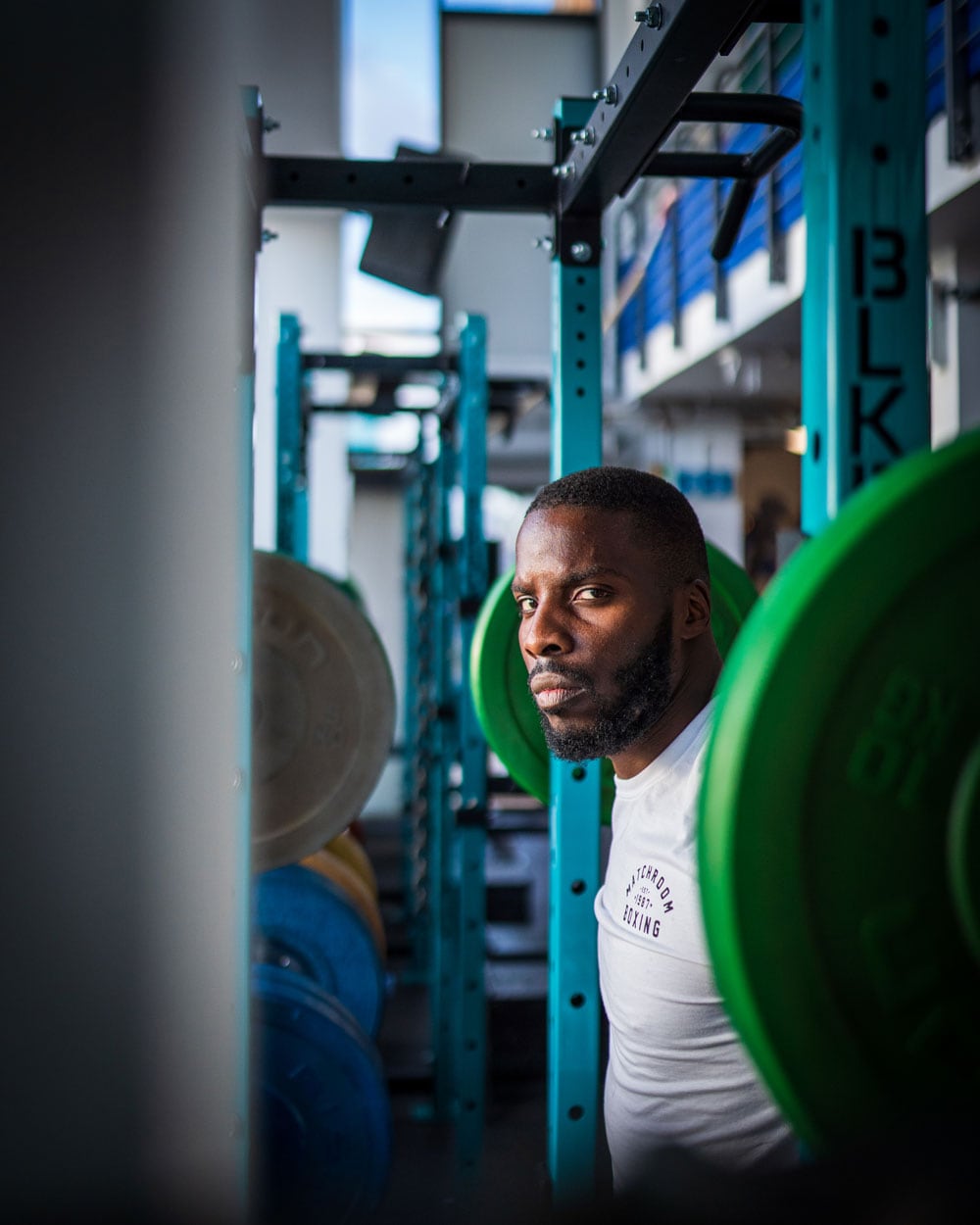 Lawrence Okolie getting prepared to perform squat workouts.